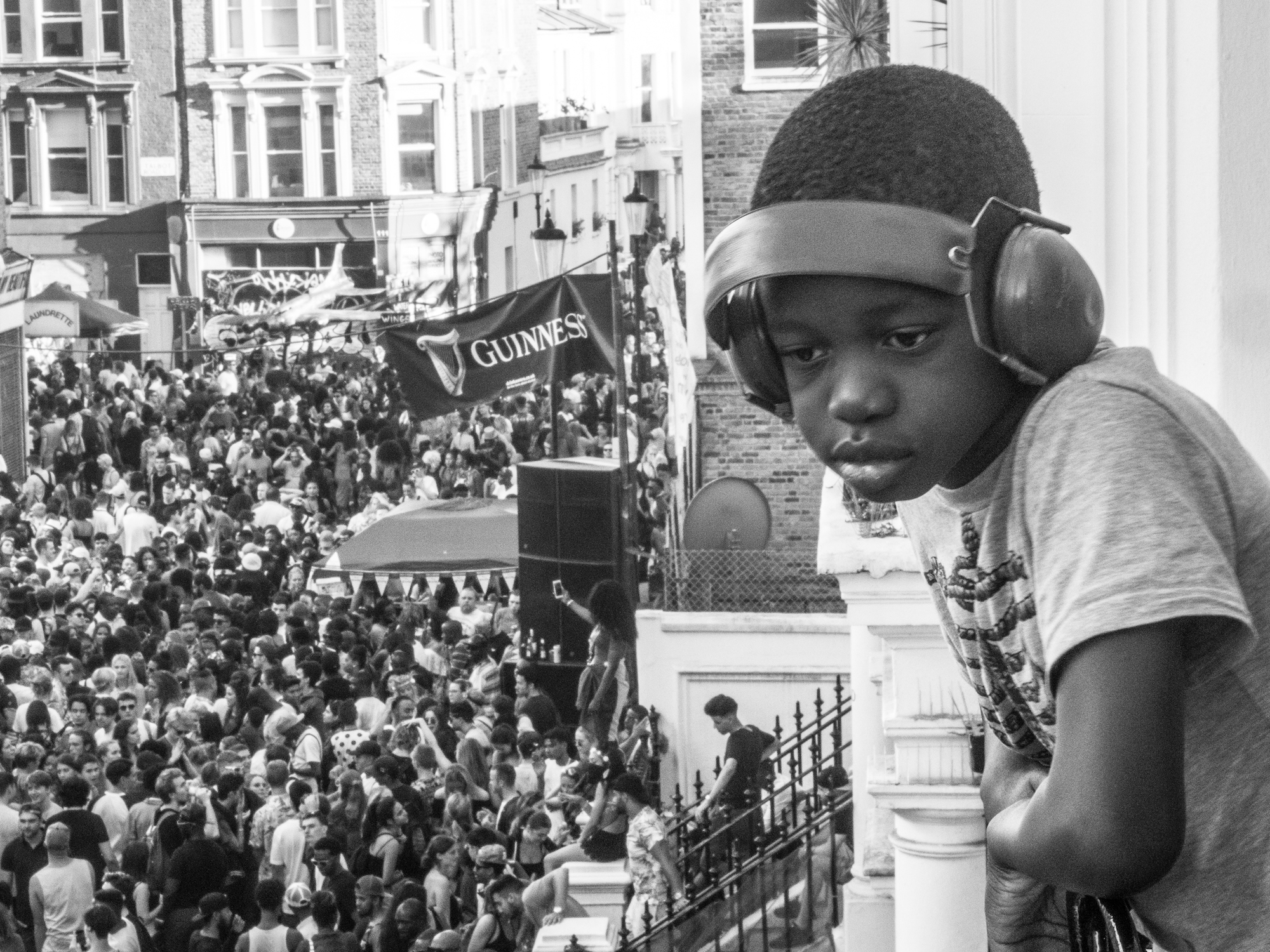 Young boy watching Carnival from a window, Notting Hill Carnival, 2016 © Babycakes Romero