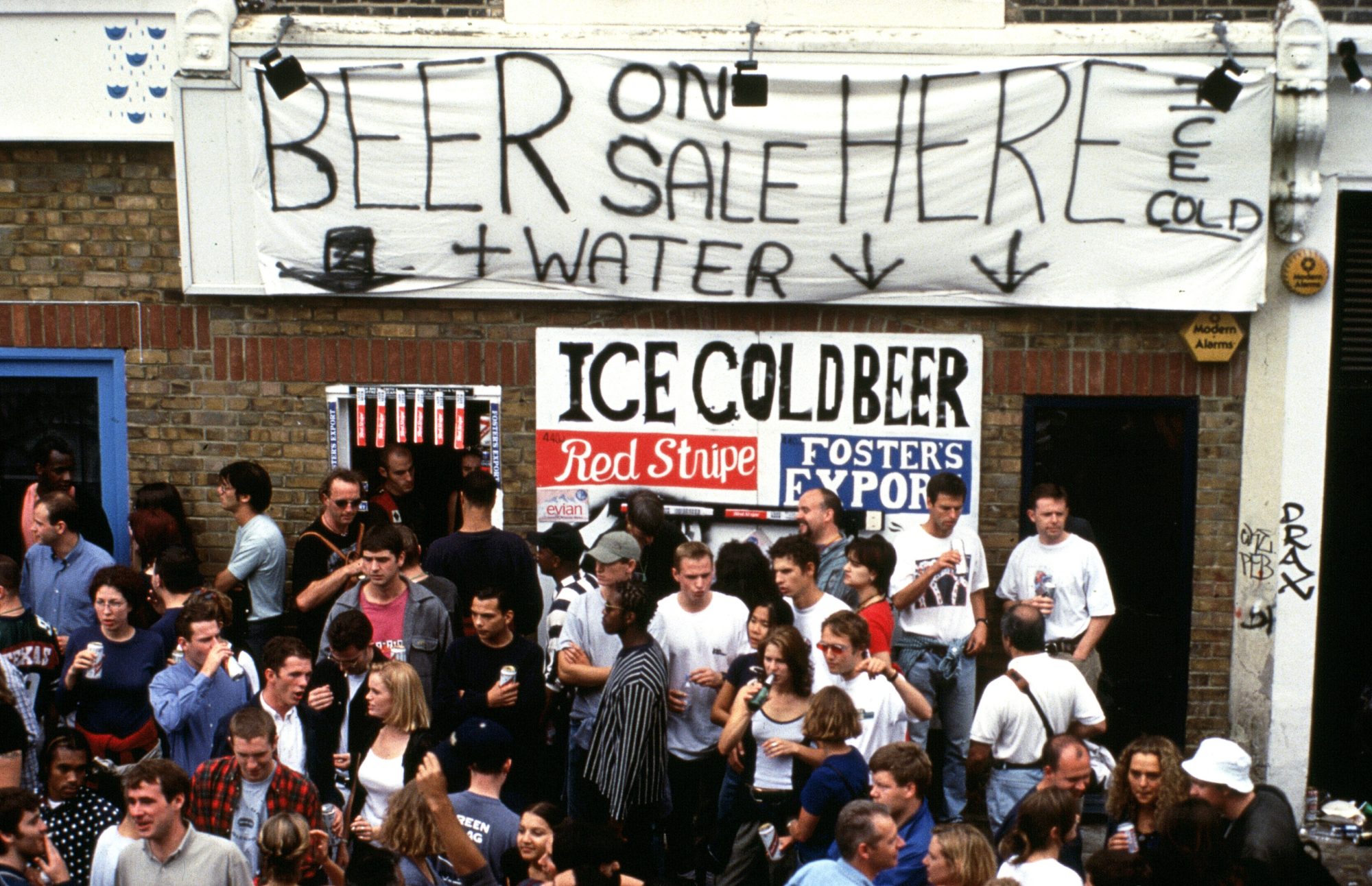 Beer on sale sign, Notting Hill Carnival, London, 1990s © Des Willie